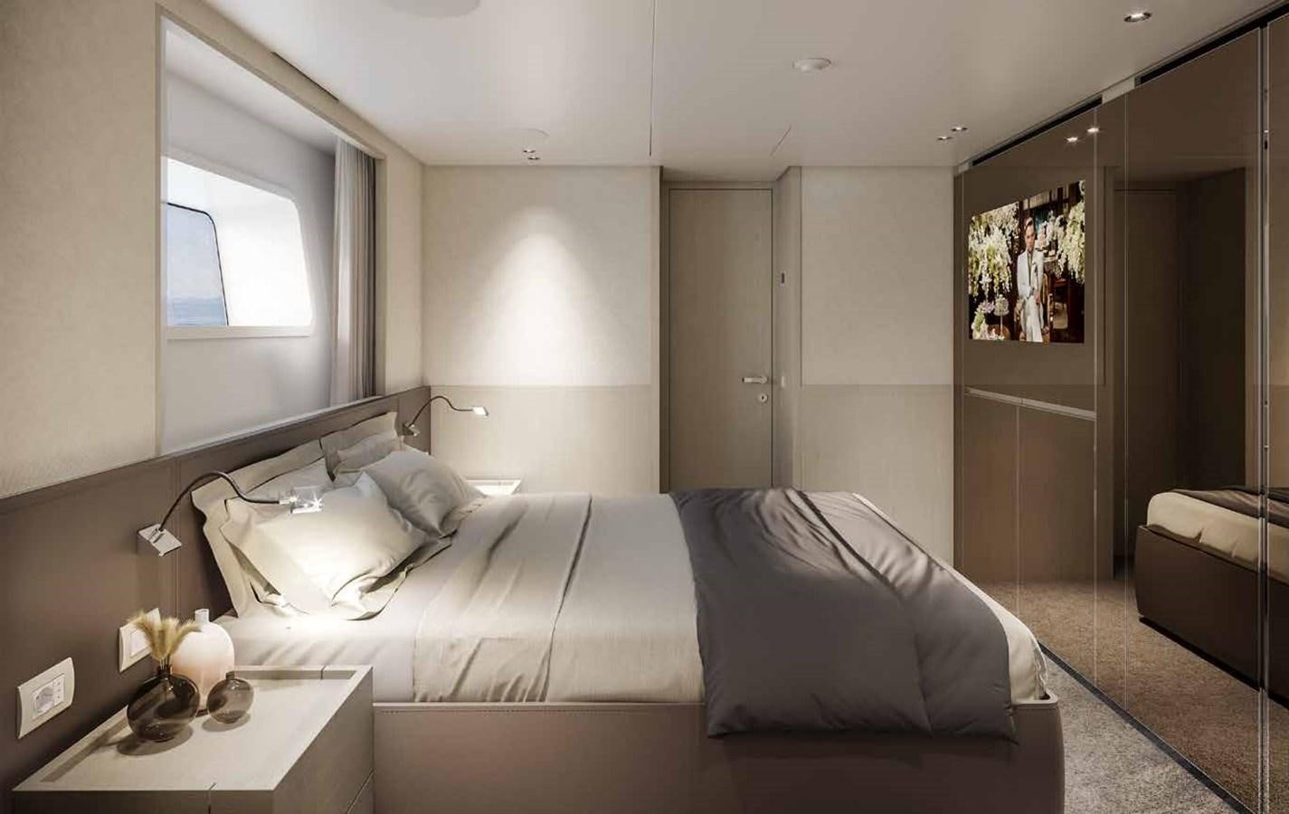 a bedroom with a bed and a desk aboard AM Yacht for Sale