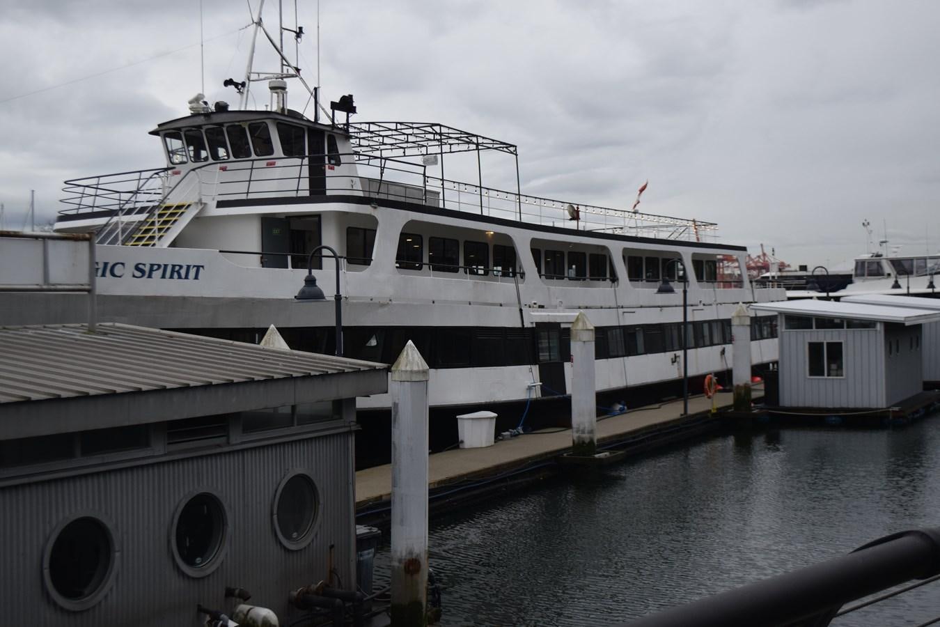 a large white boat docked at a pier aboard MAGIC SPIRIT Yacht for Sale