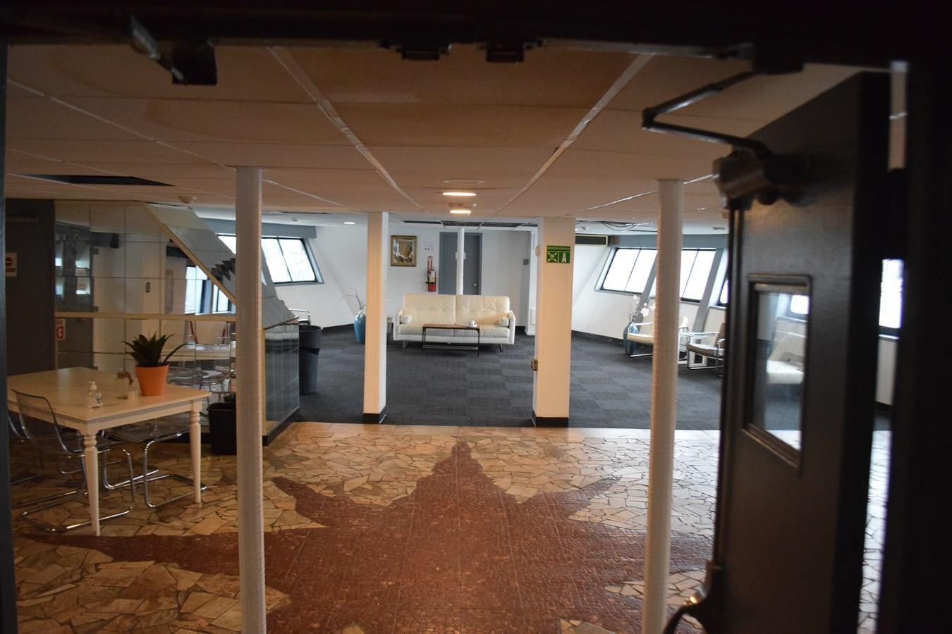 a room with a table and chairs aboard MAGIC SPIRIT Yacht for Sale