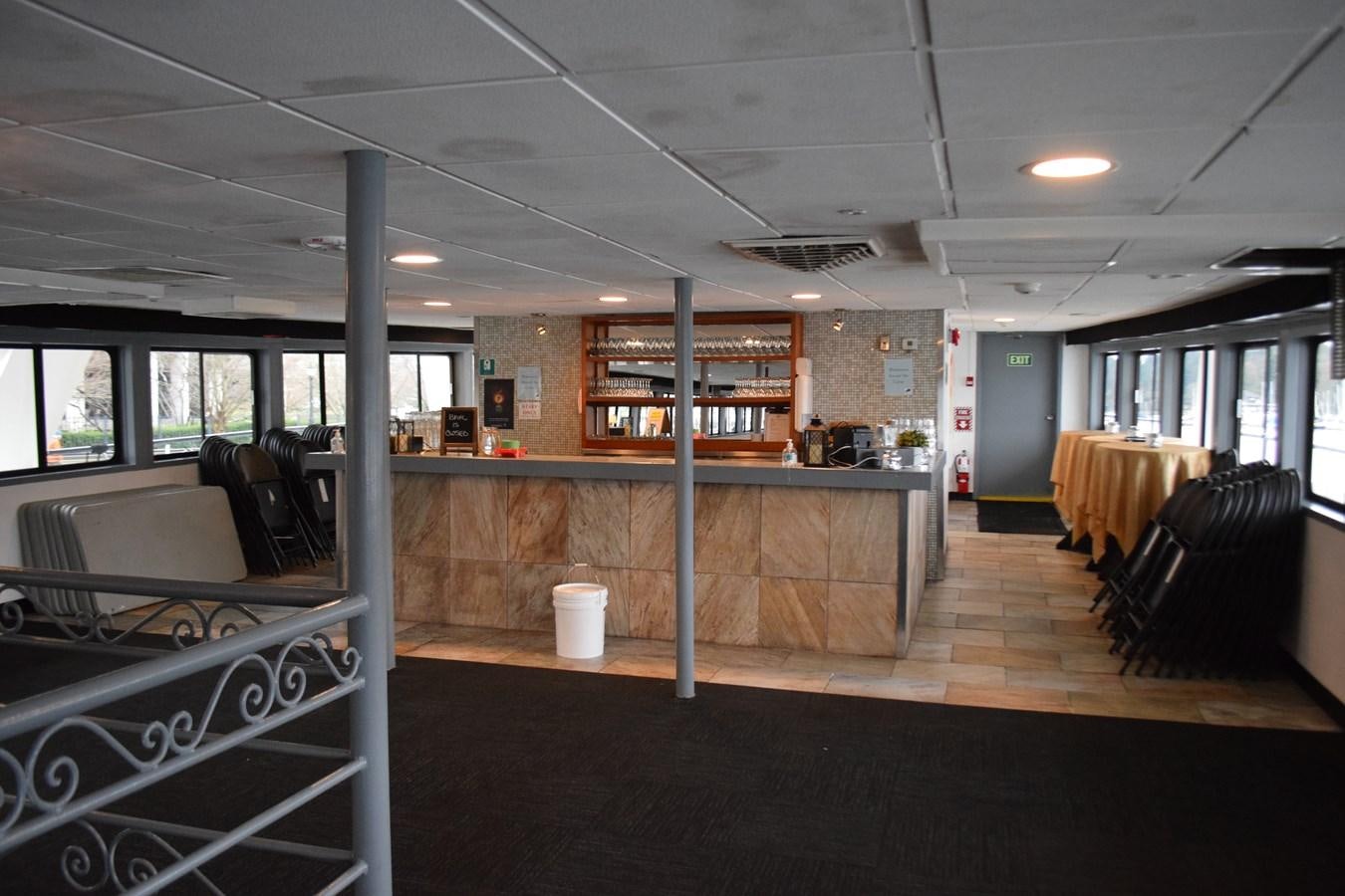 a large room with a bench and a shelf with books on it aboard MAGIC SPIRIT Yacht for Sale