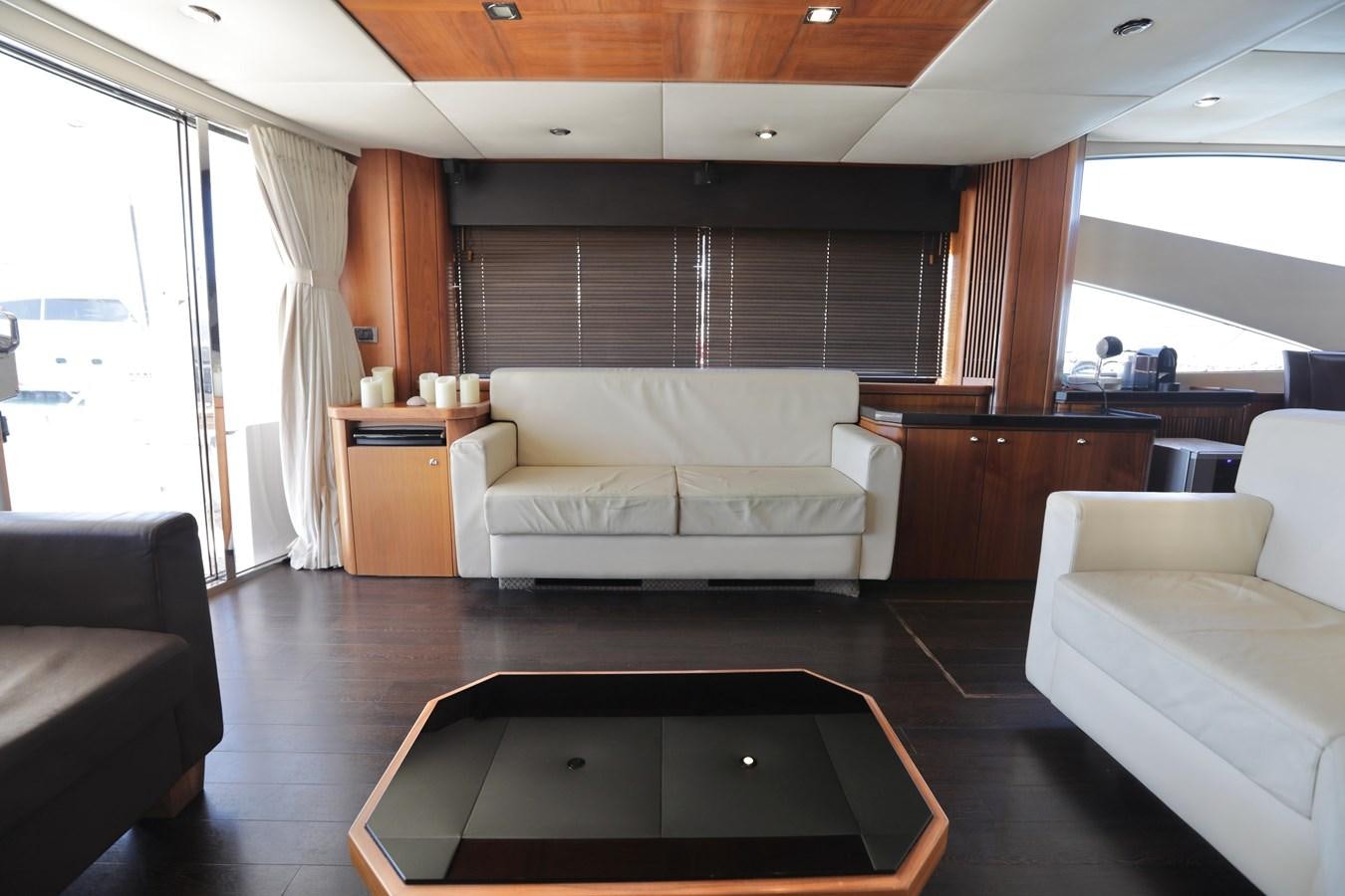 a living room with a couch and a table aboard CAPRICHO II Yacht for Sale