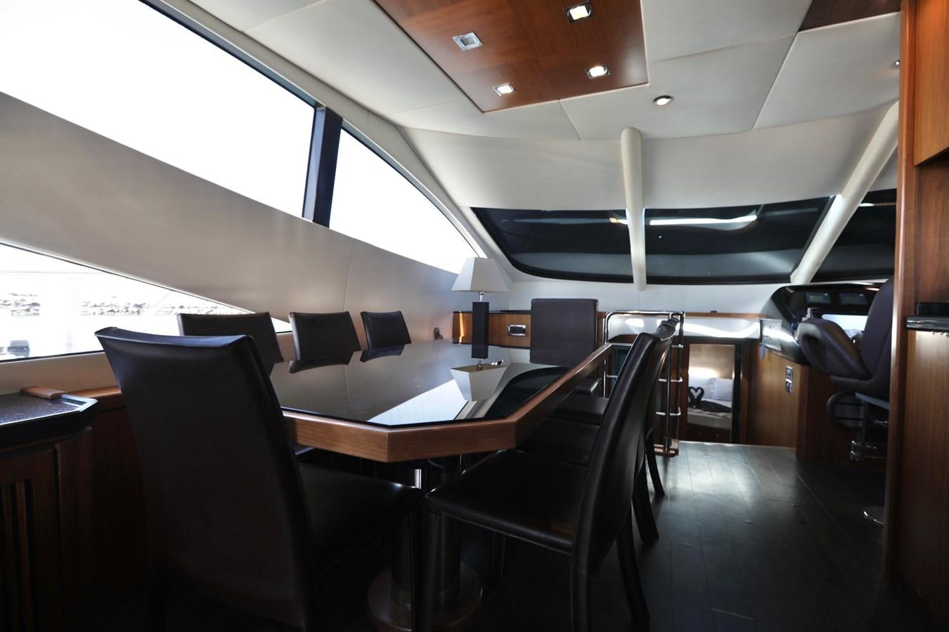 inside of a vehicle with chairs and tables aboard CAPRICHO II Yacht for Sale