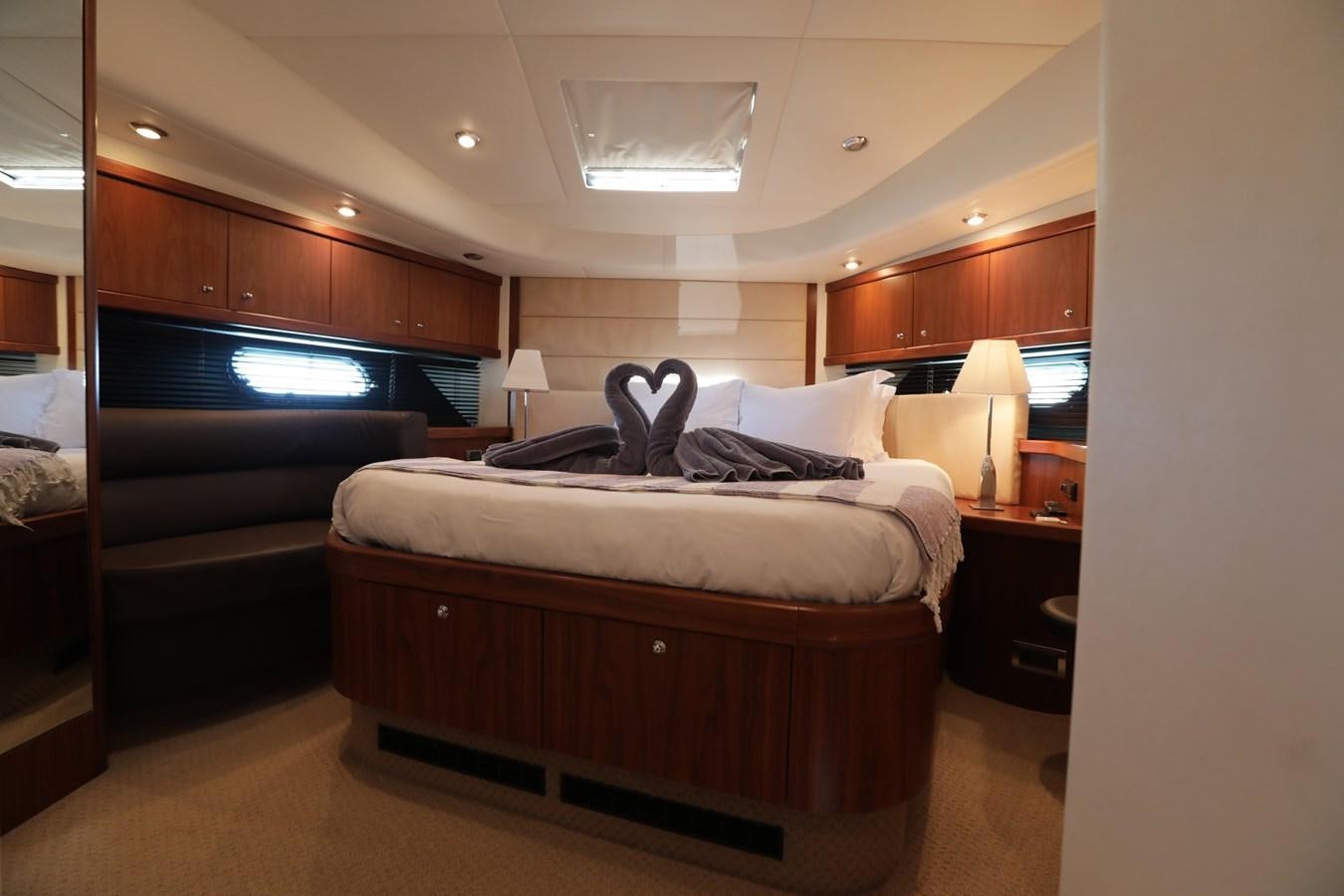 a bedroom with a bed and a tv aboard CAPRICHO II Yacht for Sale