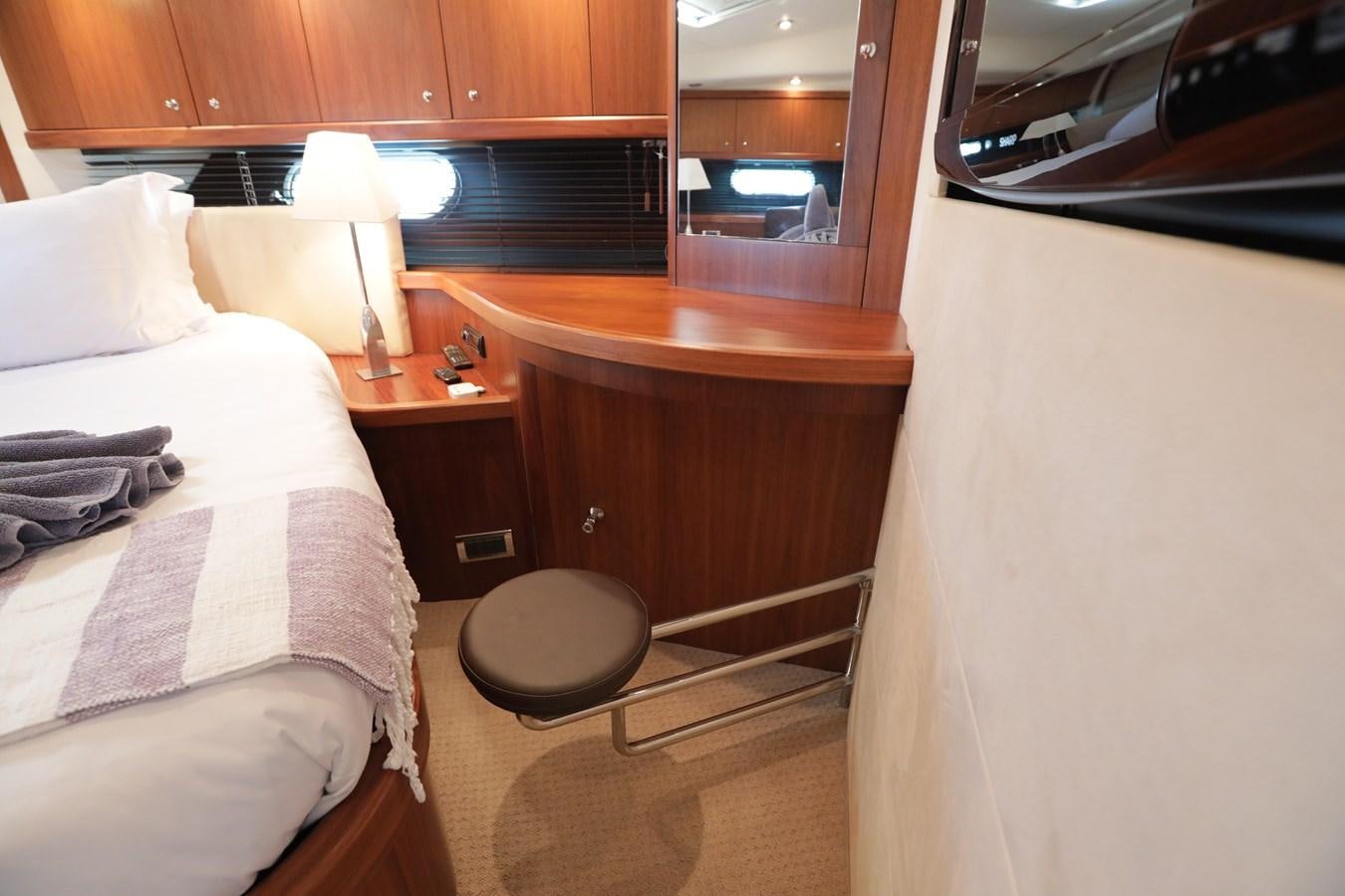 a room with a bed and a table aboard CAPRICHO II Yacht for Sale