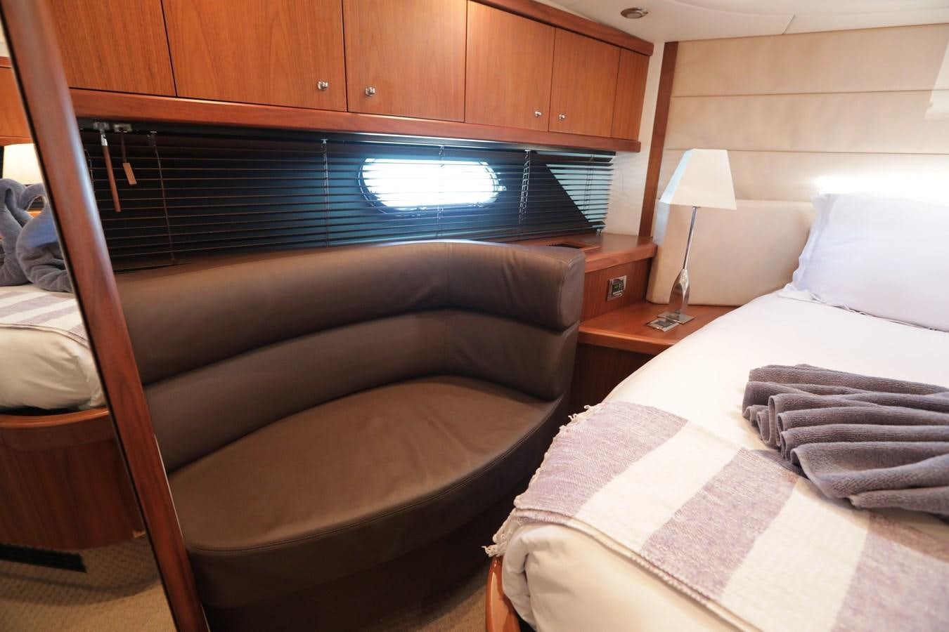 a room with a bed and a television aboard CAPRICHO II Yacht for Sale