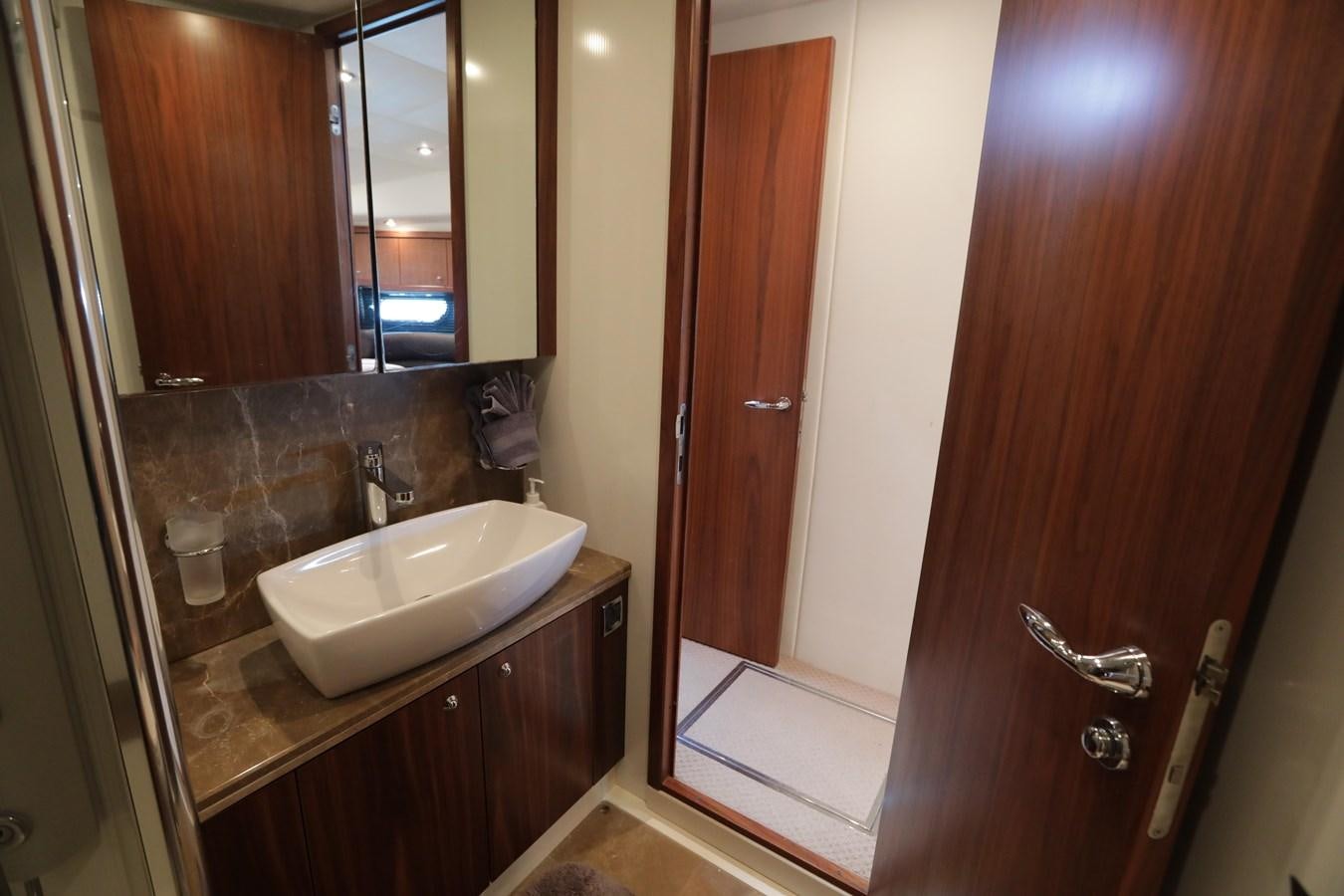 a bathroom with a sink and a mirror aboard CAPRICHO II Yacht for Sale