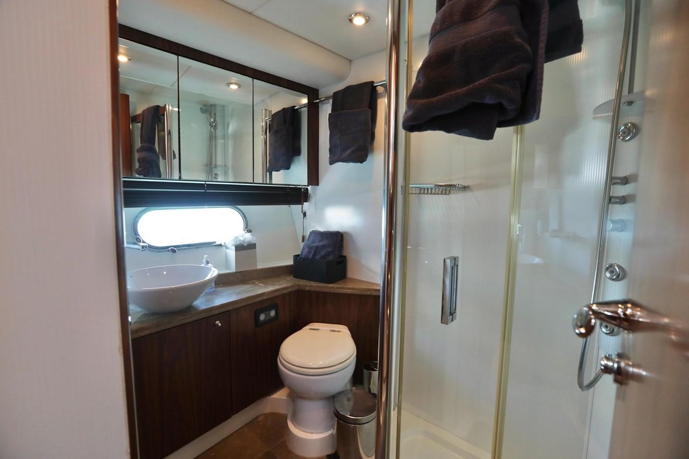 a bathroom with a glass shower door aboard CAPRICHO II Yacht for Sale