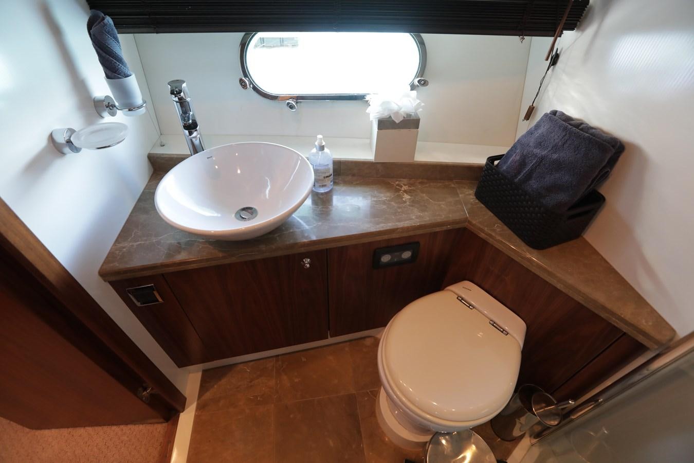 a bathroom with a sink and toilet aboard CAPRICHO II Yacht for Sale