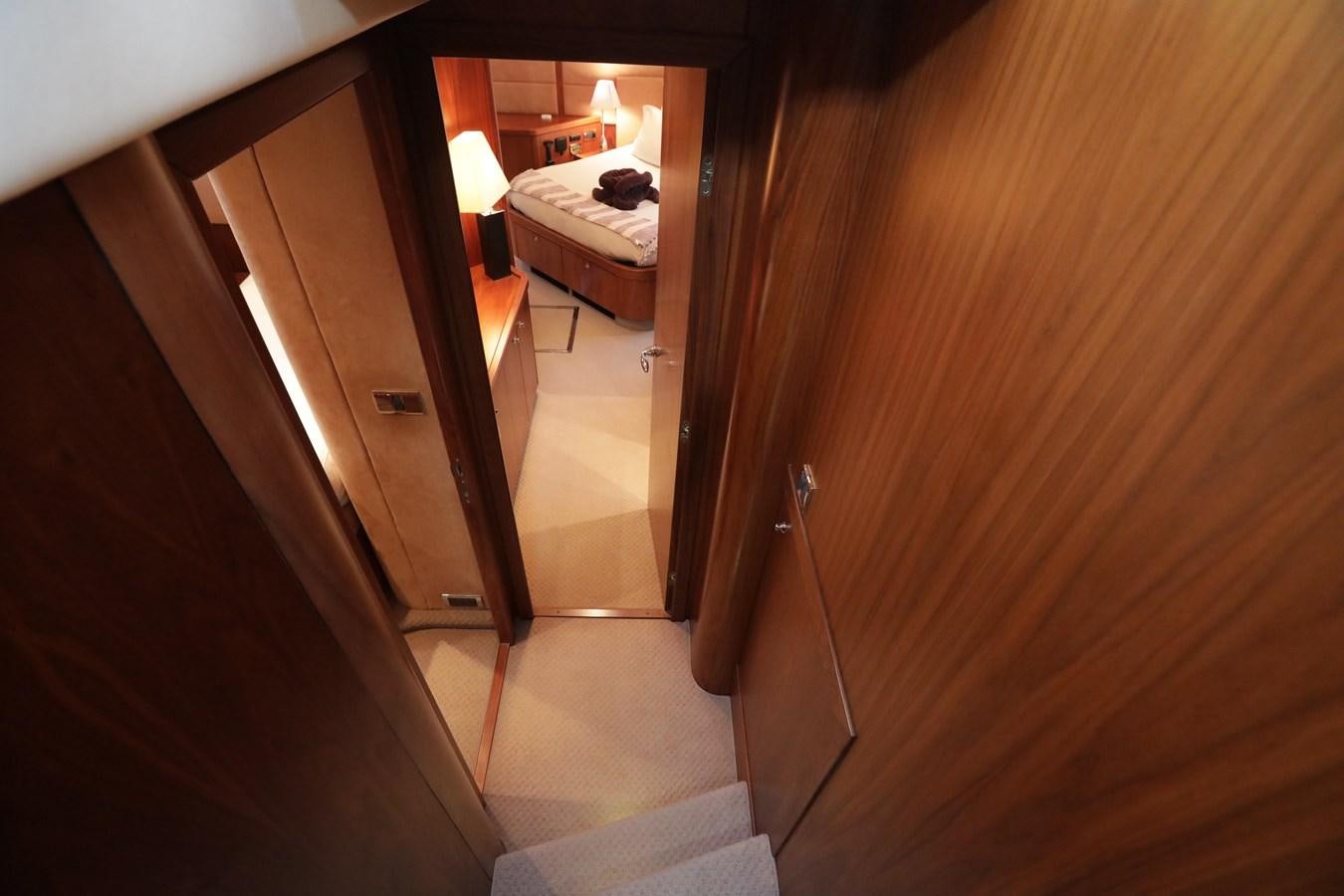 a hallway with a bed and a door aboard CAPRICHO II Yacht for Sale