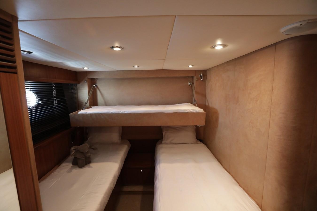 a room with a bed and a window aboard CAPRICHO II Yacht for Sale