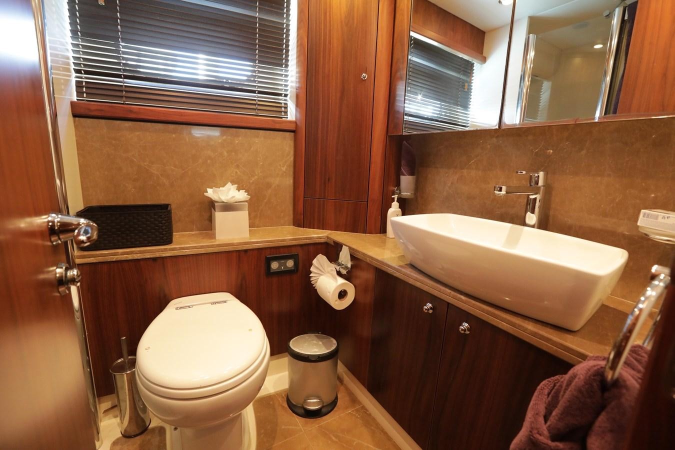 a bathroom with a toilet and sink aboard CAPRICHO II Yacht for Sale