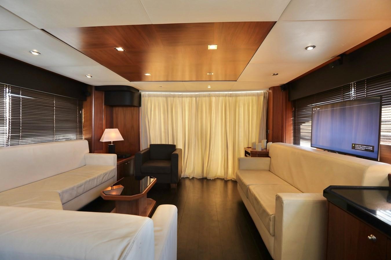 a living room with a couch and a television aboard CAPRICHO II Yacht for Sale