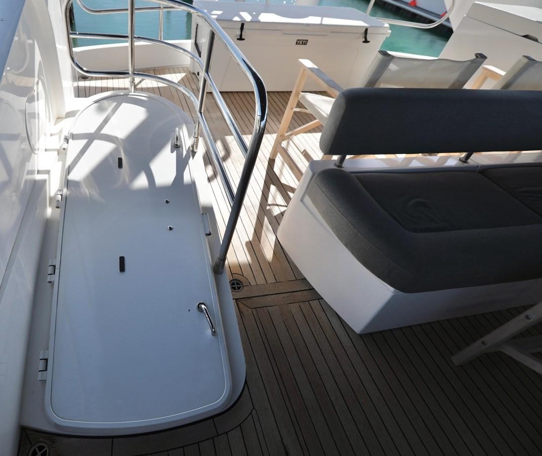 a white rectangular object with a black seat aboard CAPRICHO II Yacht for Sale