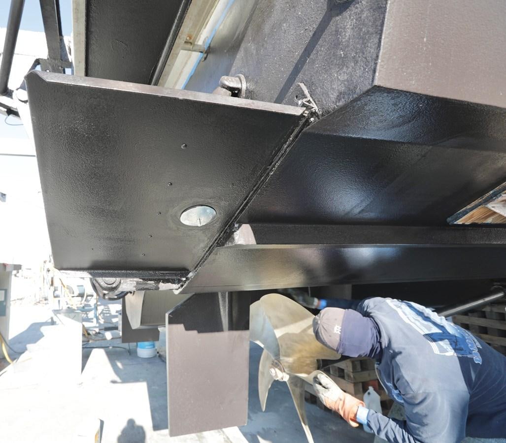 a person working on a machine aboard CAPRICHO II Yacht for Sale