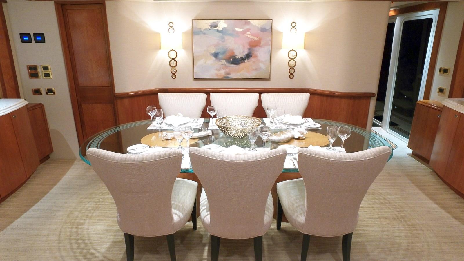 a dining table with chairs aboard SHORT GAME Yacht for Sale