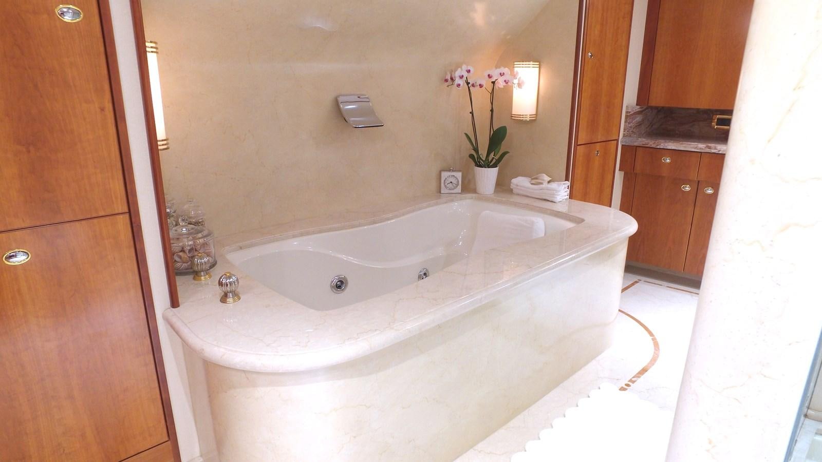 a bathtub with flowers in a bathroom aboard SHORT GAME Yacht for Sale