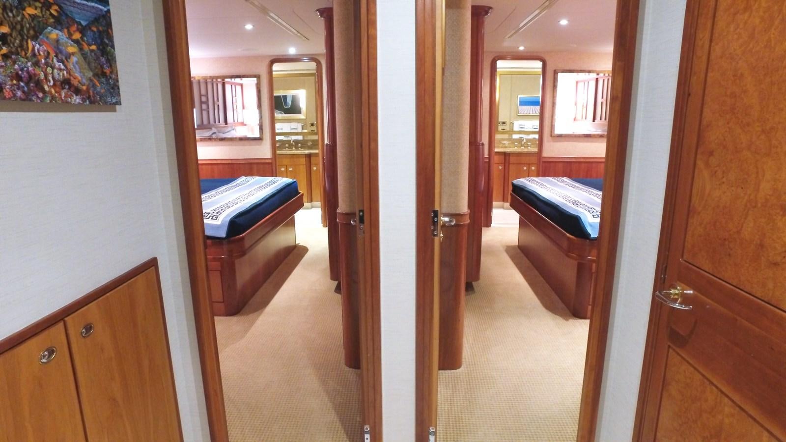 a hallway with a bed and a desk aboard SHORT GAME Yacht for Sale