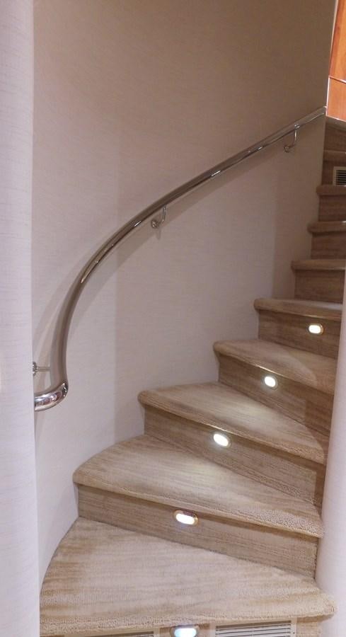 a wooden staircase with a metal railing aboard SHORT GAME Yacht for Sale