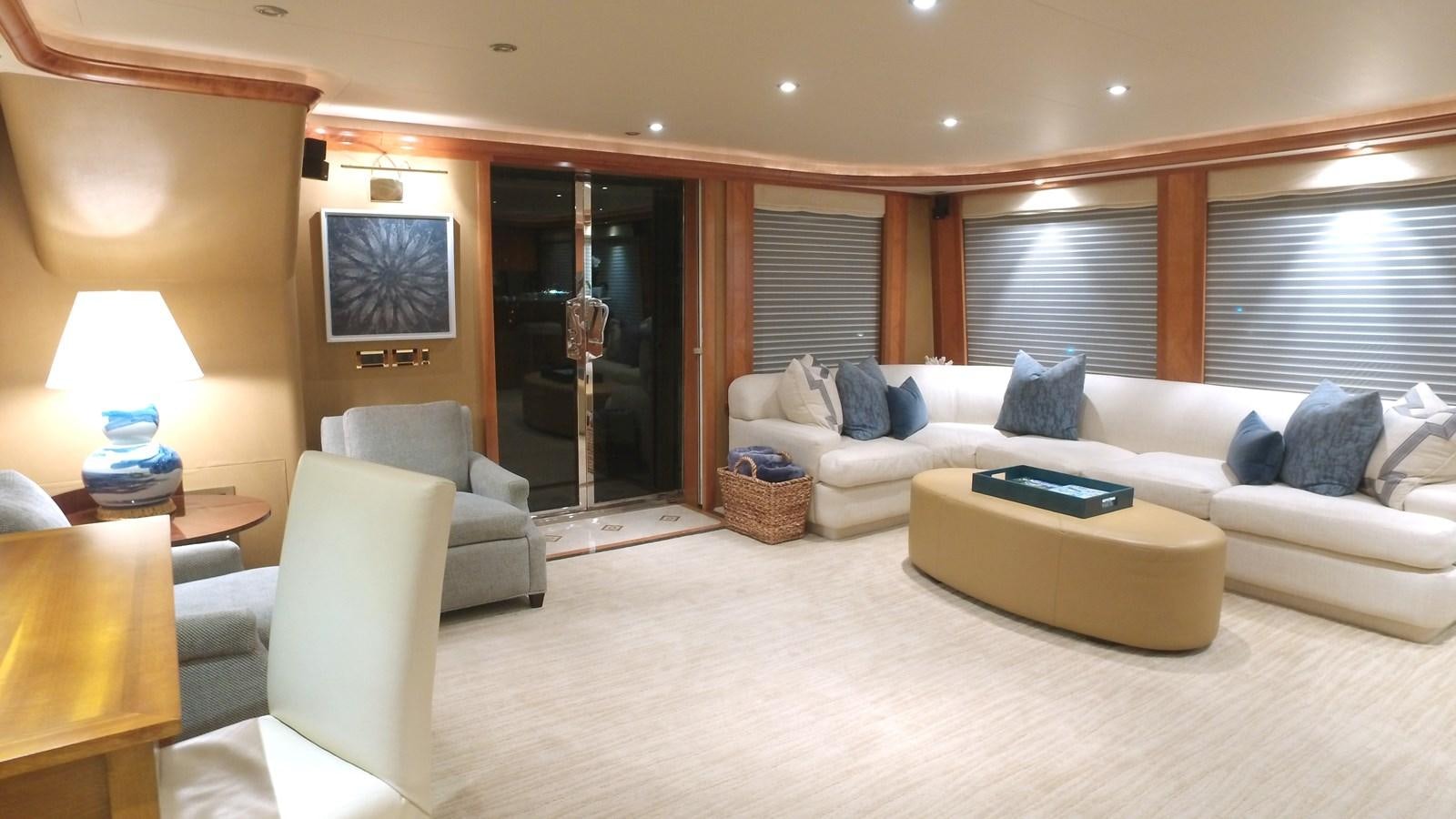 a large living room with a white couch and a large mirror aboard SHORT GAME Yacht for Sale