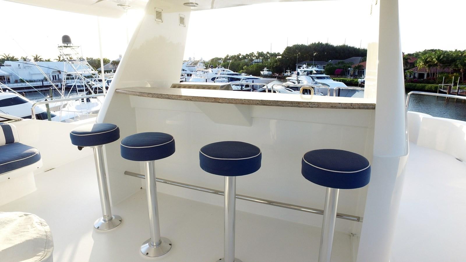 a group of stools on a balcony overlooking a parking lot aboard SHORT GAME Yacht for Sale