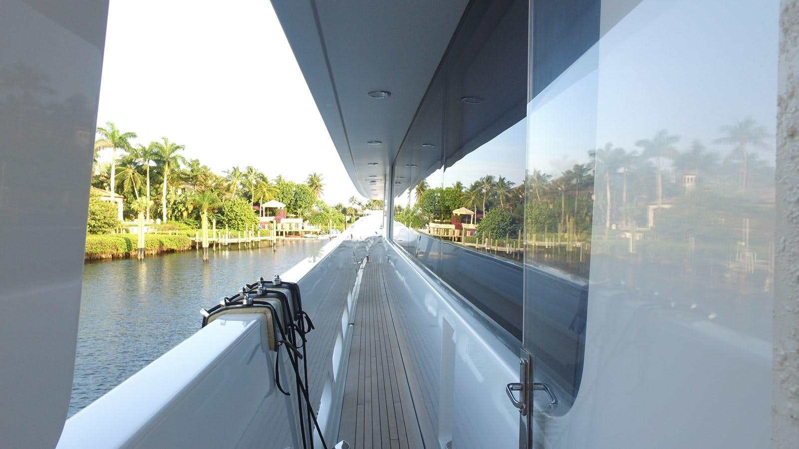a large white boat with a white canopy on a body of water aboard SHORT GAME Yacht for Sale