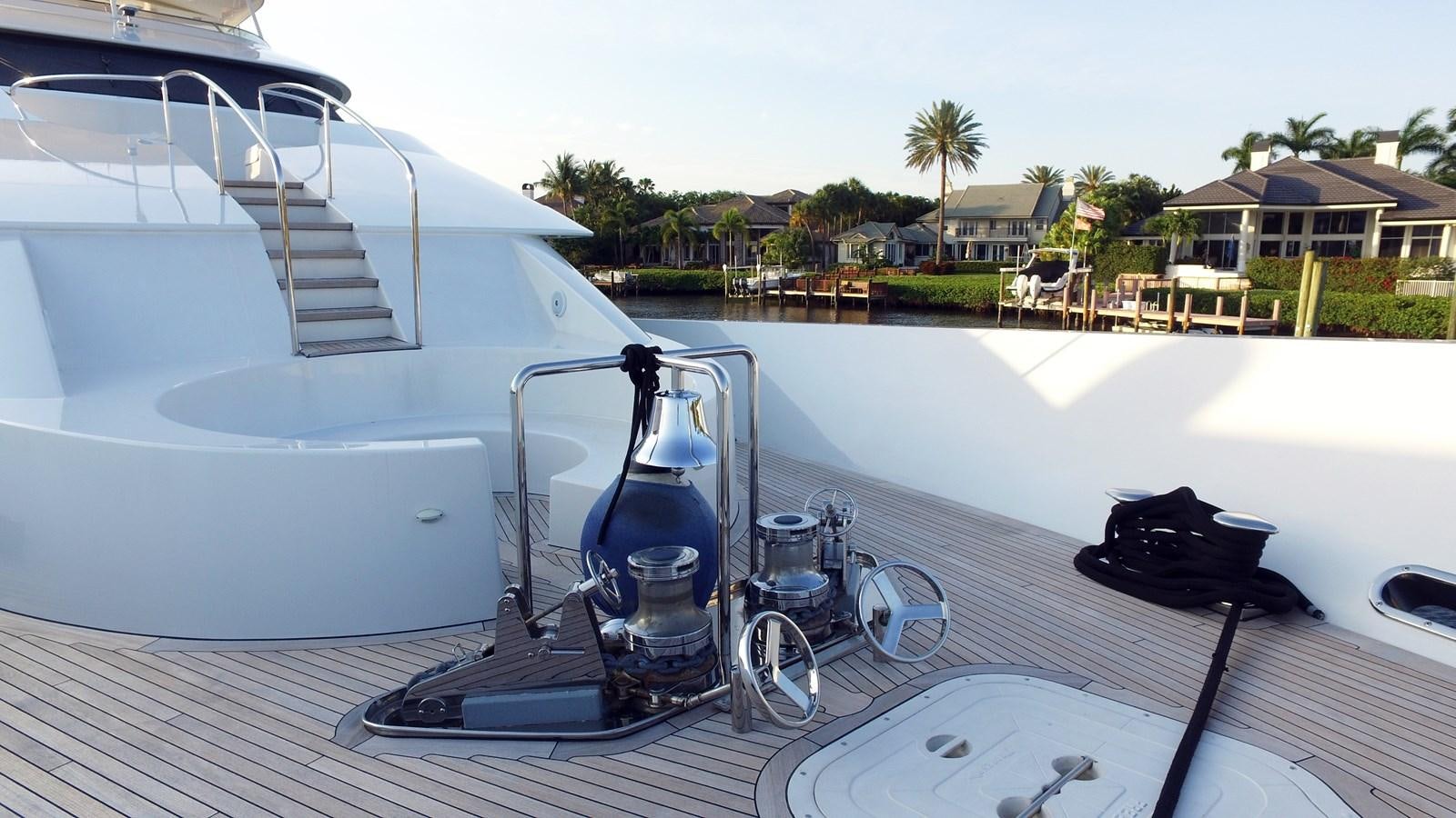 a deck with a boat and a water bottle on it aboard SHORT GAME Yacht for Sale