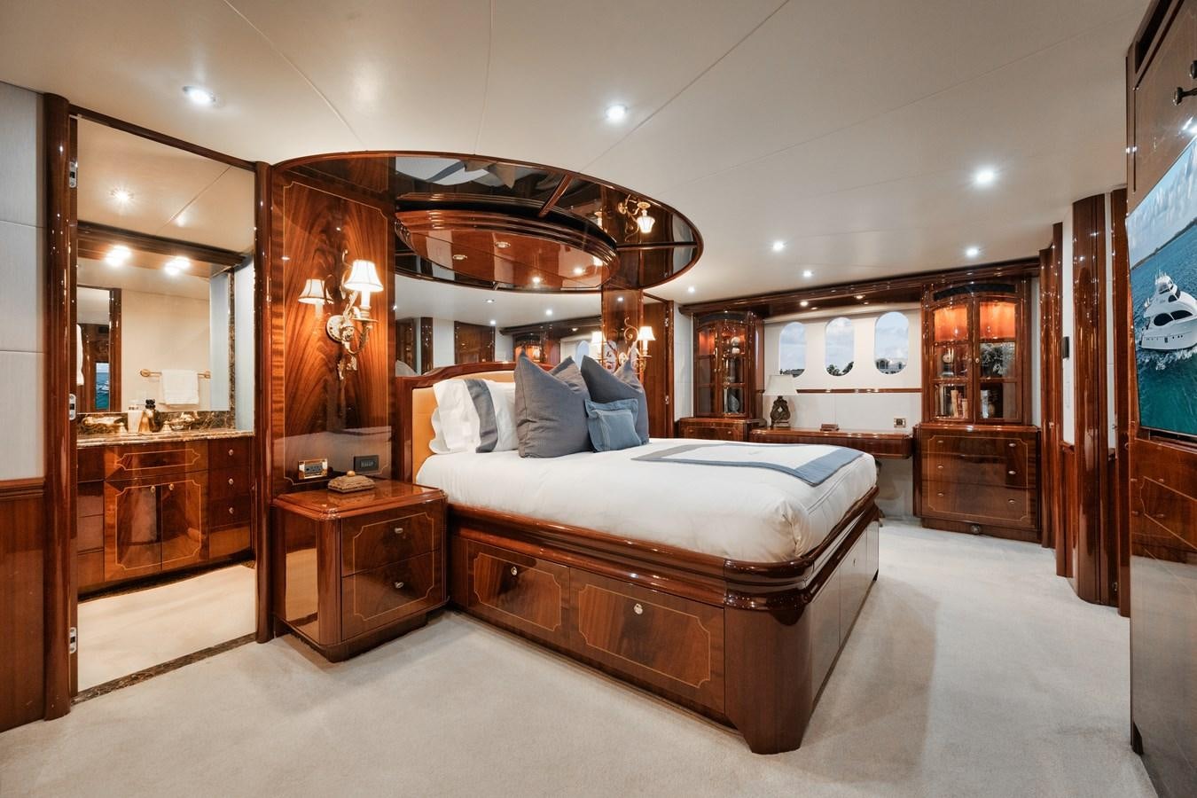 a bedroom with a bed and a dresser aboard BELLA CONTESSA Yacht for Sale
