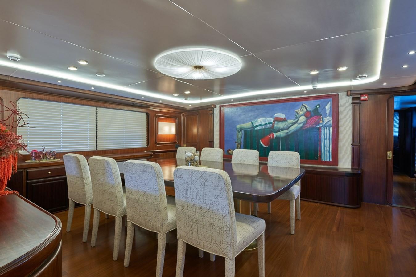 a large room with tables and chairs aboard EL CARAN Yacht for Sale