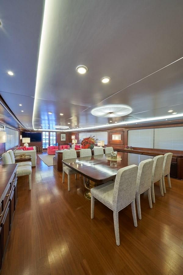 a large room with a table and chairs aboard EL CARAN Yacht for Sale