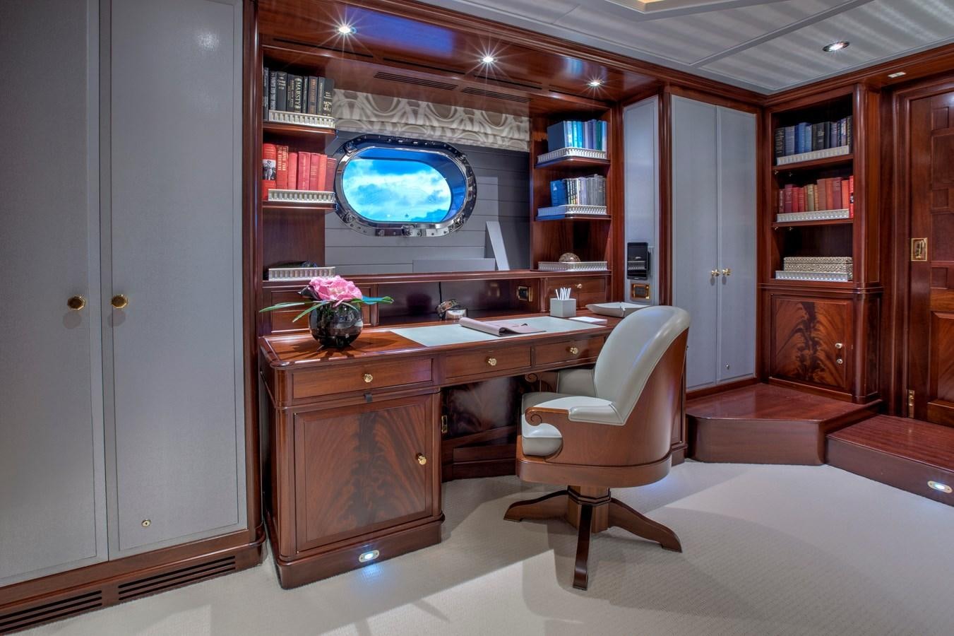 a room with a desk and chairs aboard MARE NOSTRUM Yacht for Sale