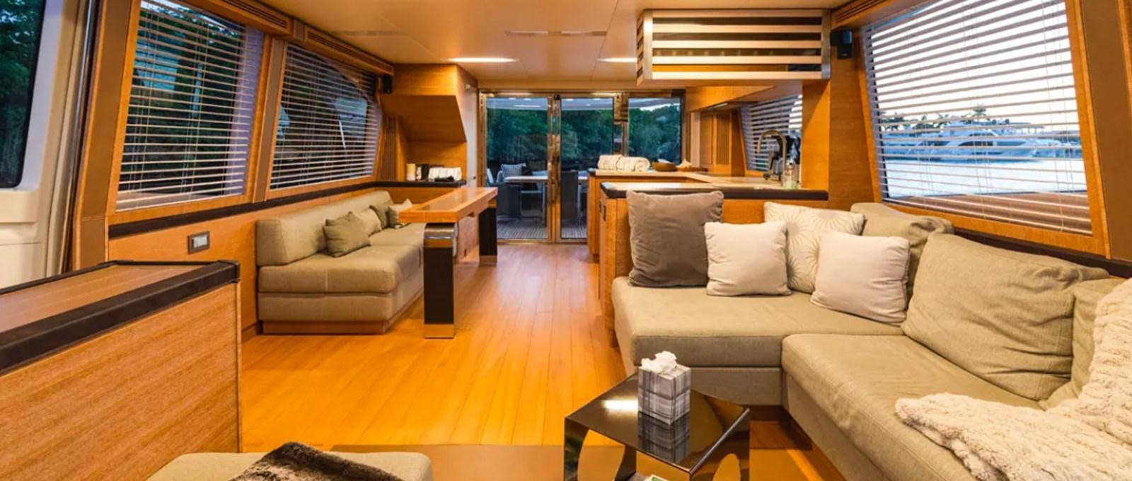 a living room with a couch and a coffee table aboard MANILA Yacht for Sale