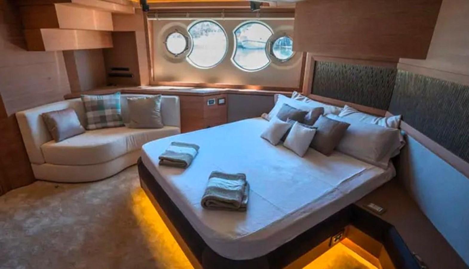 a bed with a blue sheet aboard MANILA Yacht for Sale