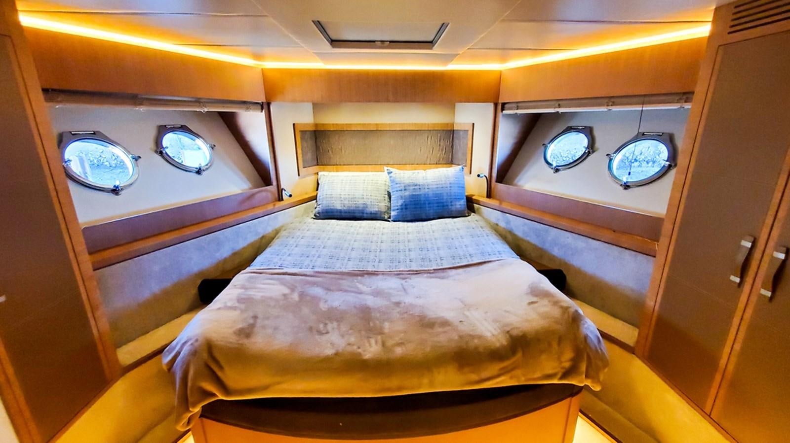 a room with a bed and a fan aboard MANILA Yacht for Sale