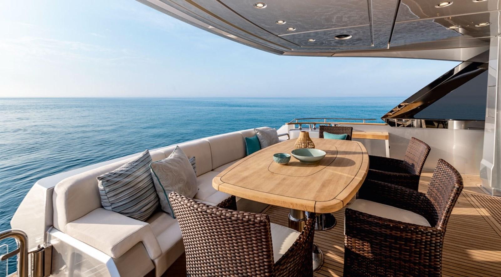 a table and chairs on a deck aboard MANILA Yacht for Sale