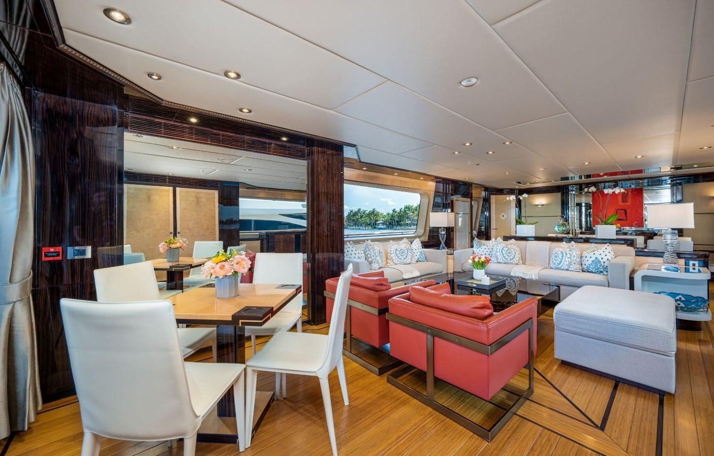 a room with a table chairs and a couch aboard VESPER Yacht for Sale