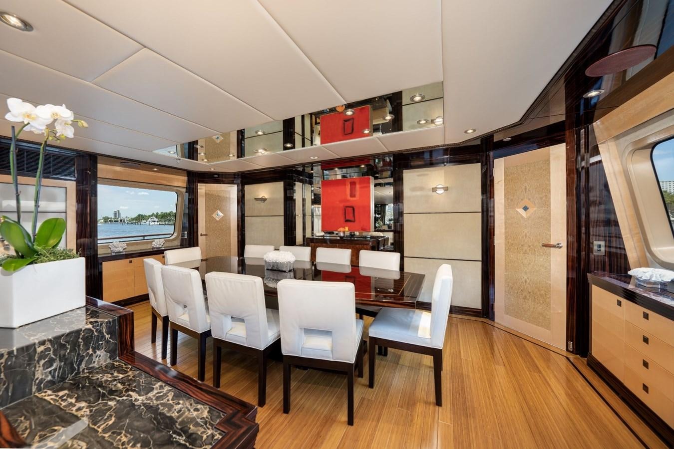 a room with a table and chairs aboard VESPER Yacht for Sale