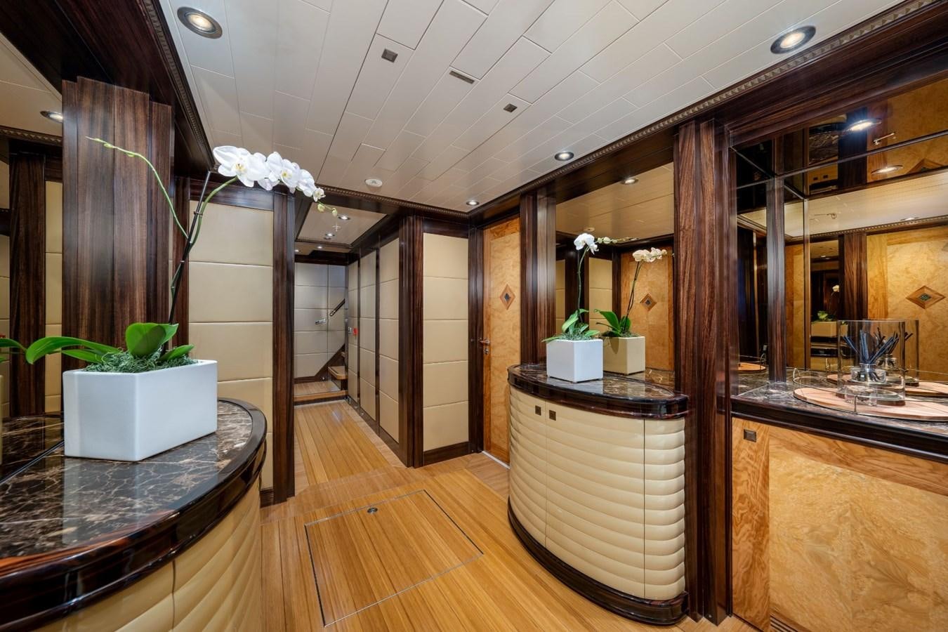 a room with a large glass display case and a plant in a pot aboard VESPER Yacht for Sale