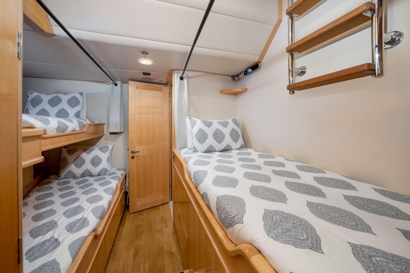 a bedroom with two beds aboard VESPER Yacht for Sale