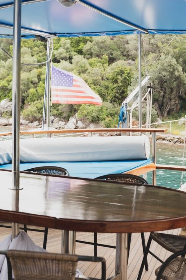 a table with a flag on it aboard ROYAL MARIS Yacht for Sale
