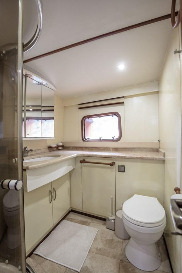 a bathroom with a toilet sink and a window aboard ROYAL MARIS Yacht for Sale