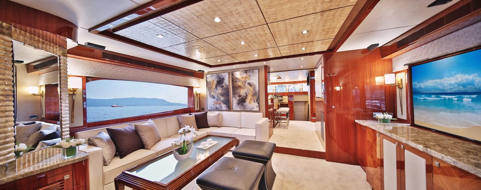 a room with a large window and a couch aboard JOHNSON 80' SKYLOUNGE W/HYDRAULIC PLATFORM Yacht for Sale