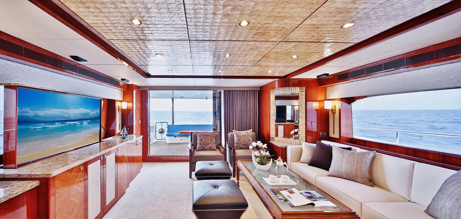 a room with a large window and a large television aboard JOHNSON 80' SKYLOUNGE W/HYDRAULIC PLATFORM Yacht for Sale