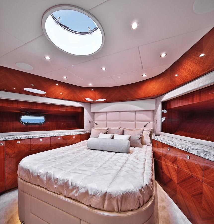 a room with a bed and a window aboard JOHNSON 80' SKYLOUNGE W/HYDRAULIC PLATFORM Yacht for Sale