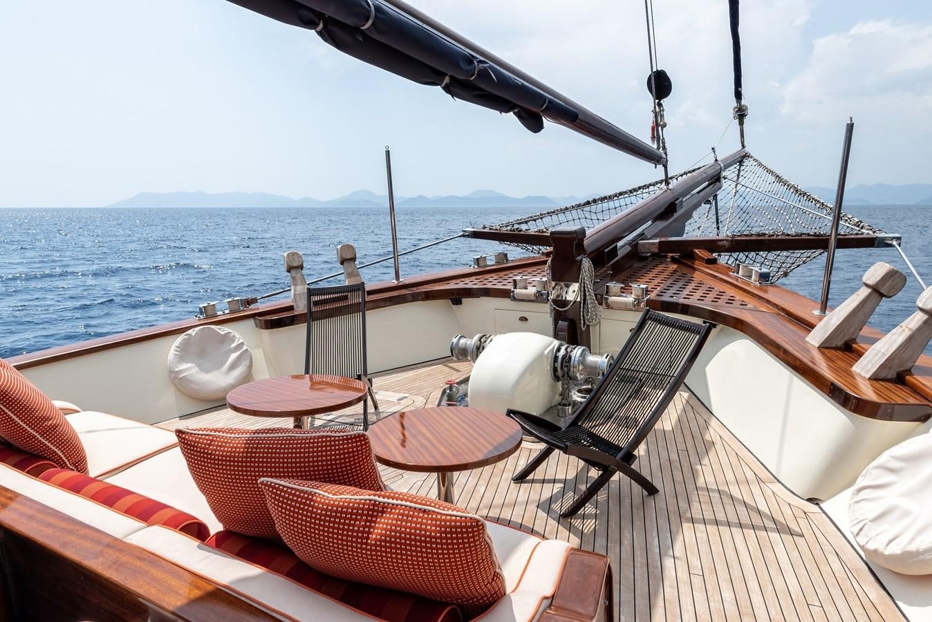 a deck with a view of the ocean and a boat aboard CAPTAIN COOK Yacht for Sale