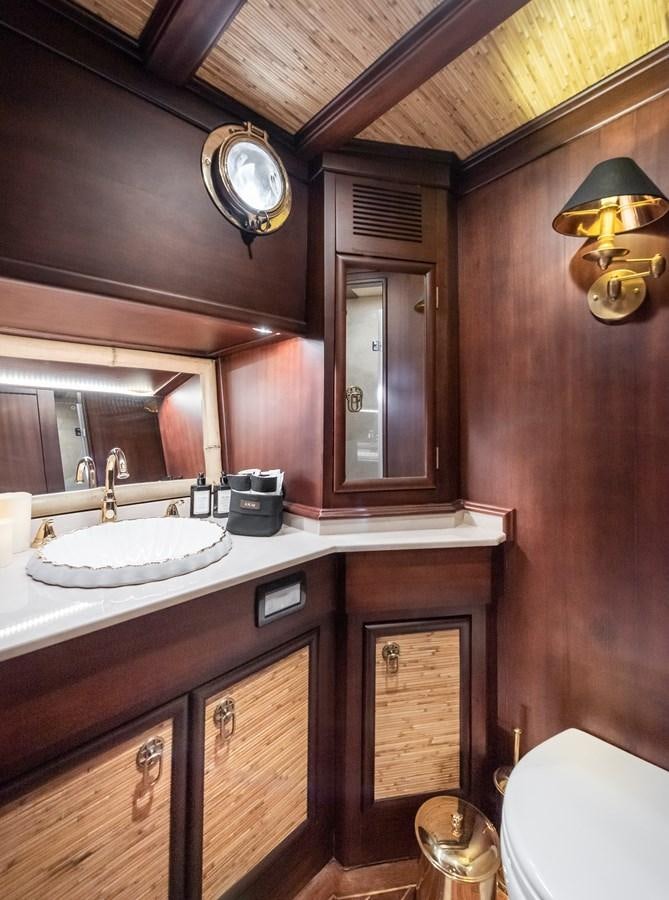 a bathroom with a sink and a mirror aboard CAPTAIN COOK Yacht for Sale