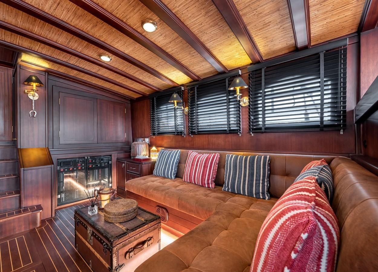 a living room with a fireplace aboard CAPTAIN COOK Yacht for Sale