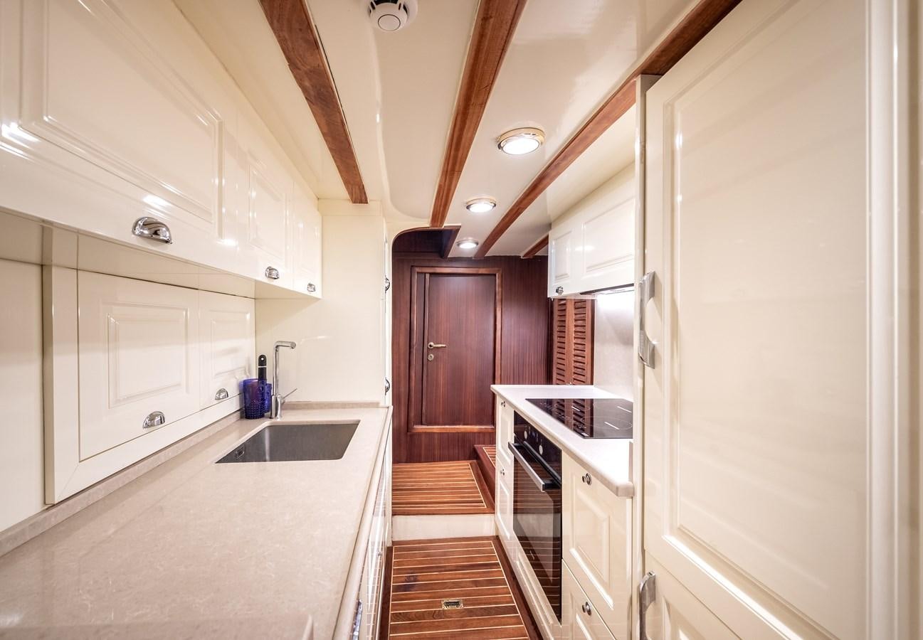 a kitchen with white cabinets aboard CAPTAIN COOK Yacht for Sale