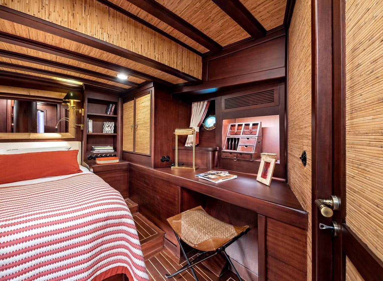 a room with a bed and a desk aboard CAPTAIN COOK Yacht for Sale