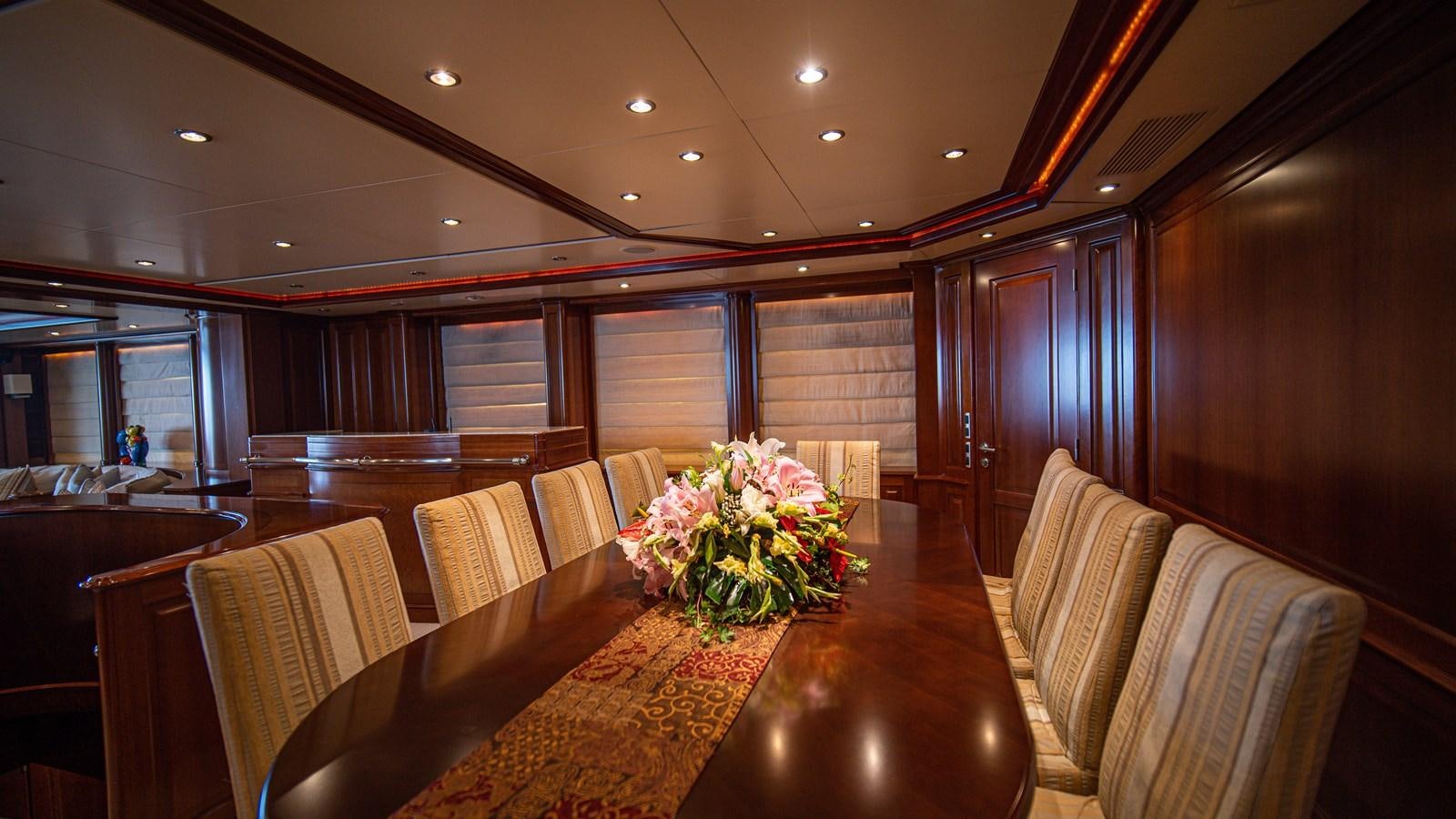a room with a table and chairs aboard ORINOKIA Yacht for Sale