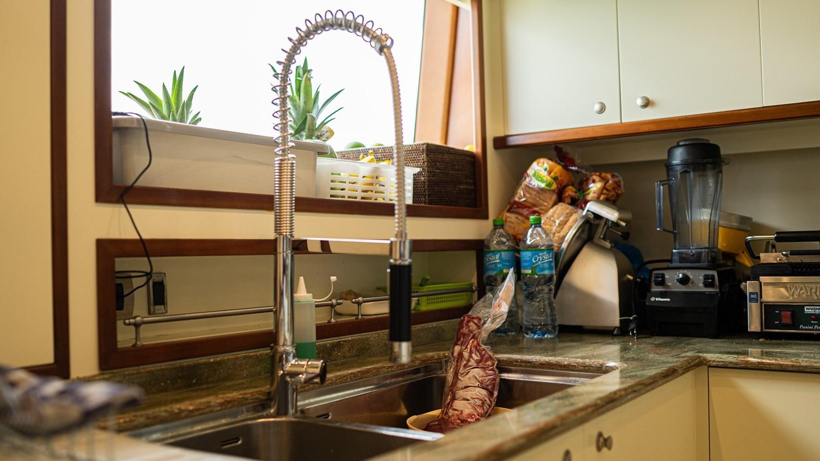 a kitchen with a fish tank aboard ORINOKIA Yacht for Sale